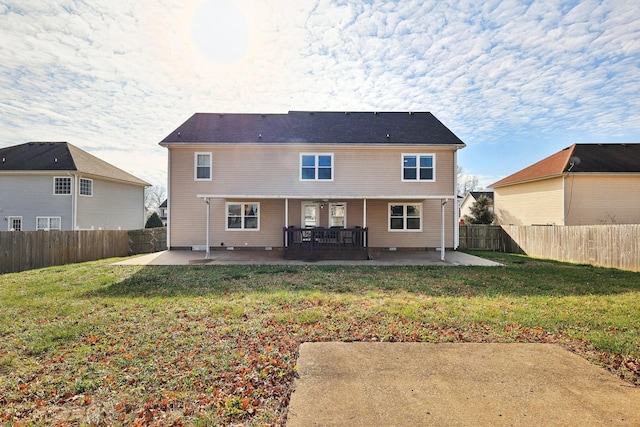 back of house with a yard and a patio area