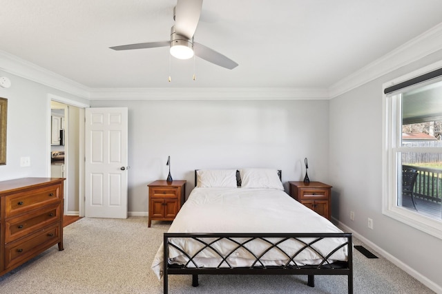 bedroom featuring multiple windows, ceiling fan, crown molding, and light carpet