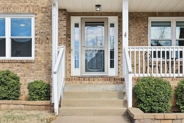 view of exterior entry with covered porch