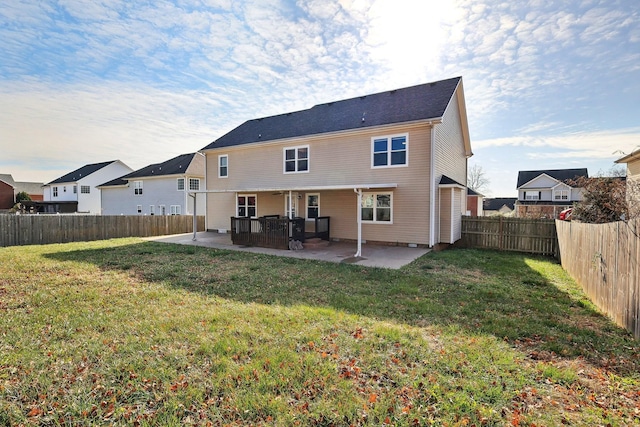 rear view of property with a patio area and a lawn