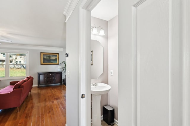 bathroom with hardwood / wood-style flooring, sink, and an inviting chandelier