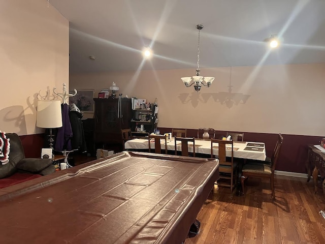 game room with dark hardwood / wood-style flooring, pool table, and an inviting chandelier