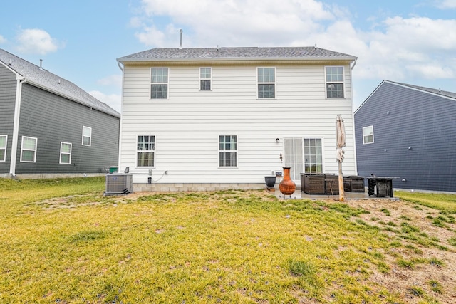 rear view of house featuring central AC unit, a yard, and a patio area