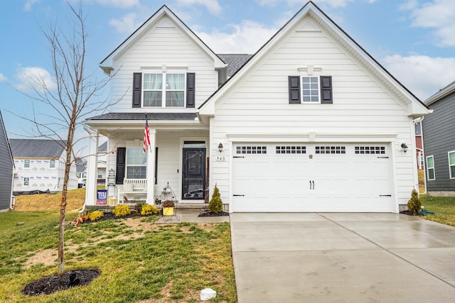 view of front of house with a porch, a garage, and a front yard