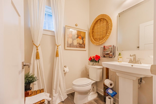 bathroom featuring hardwood / wood-style floors, sink, and toilet