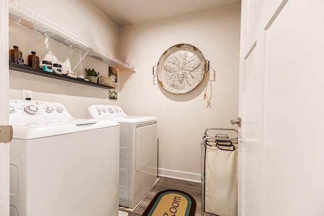 laundry room featuring dark wood-type flooring and washer and clothes dryer