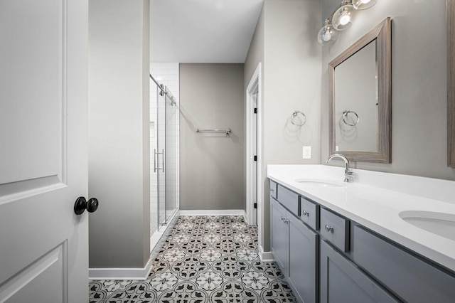 bathroom with tile patterned floors, vanity, and an enclosed shower