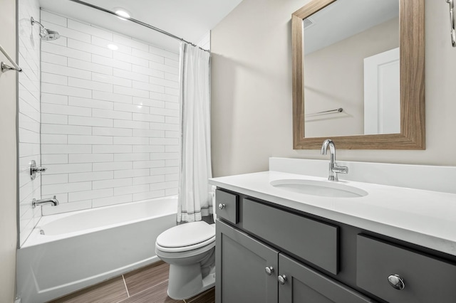 full bathroom featuring vanity, shower / tub combo, and toilet