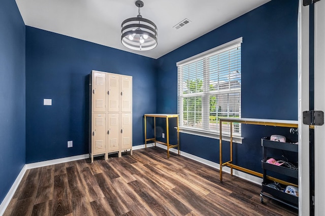 interior space with a chandelier, a closet, and dark wood-type flooring