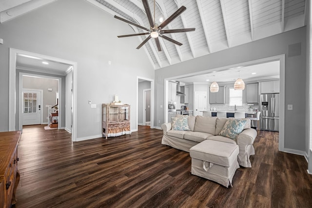 living room featuring ceiling fan, dark wood-type flooring, and high vaulted ceiling