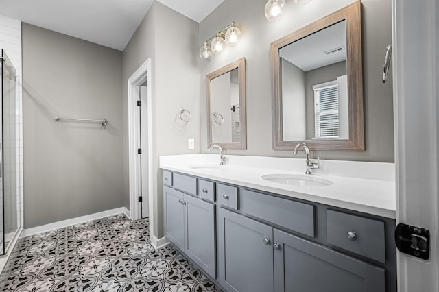 bathroom featuring tile patterned flooring, vanity, and a shower with door