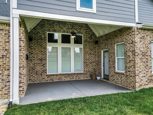 property entrance featuring ceiling fan and a patio area