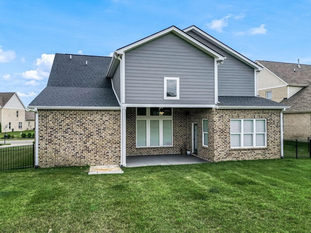 rear view of house with a yard and a patio