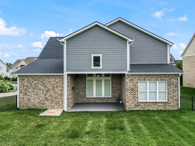 back of property featuring a patio and a lawn