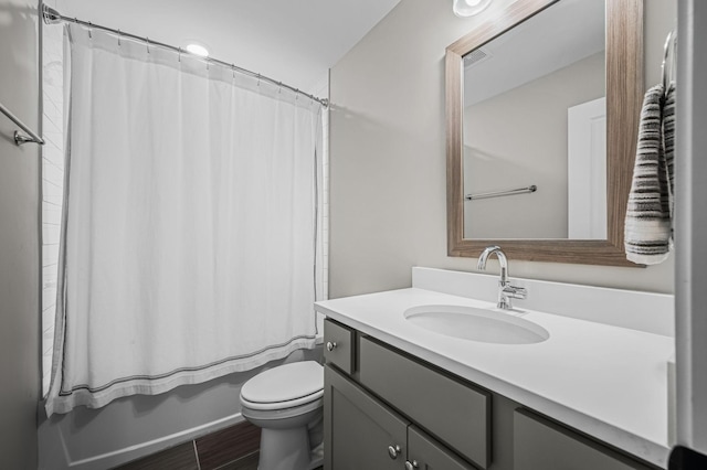 full bathroom featuring shower / bath combo with shower curtain, vanity, and toilet