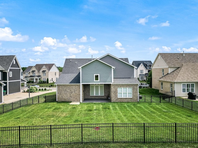 back of house with a yard