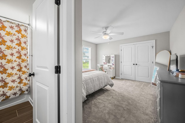 bedroom with ceiling fan, a closet, and dark carpet