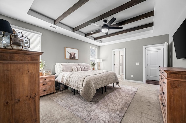 carpeted bedroom featuring beam ceiling and ceiling fan