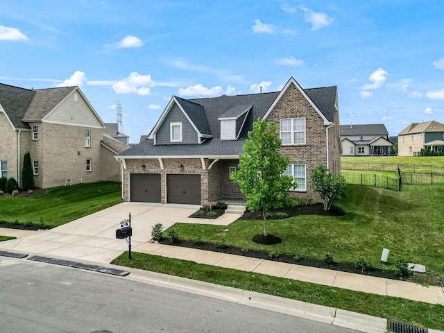 view of front of house featuring a front lawn and a garage