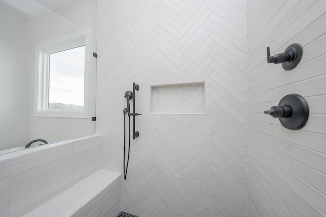 bathroom with a tile shower