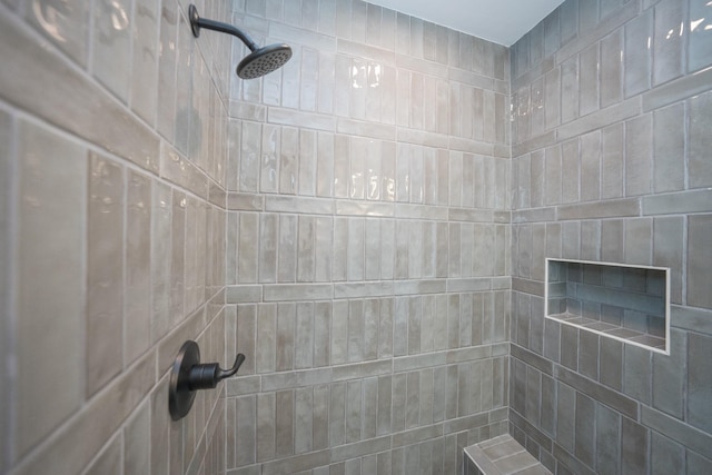 bathroom with a tile shower