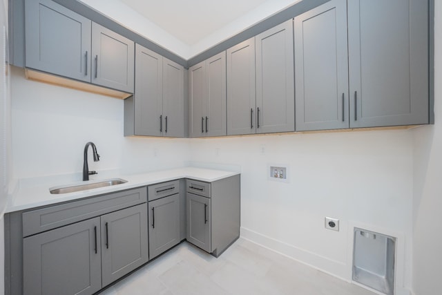 washroom featuring cabinets, hookup for a washing machine, electric dryer hookup, and sink