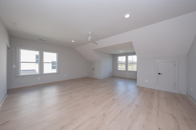 bonus room with light hardwood / wood-style floors, ceiling fan, and lofted ceiling