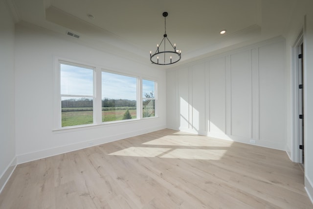 unfurnished dining area featuring light hardwood / wood-style floors and a notable chandelier