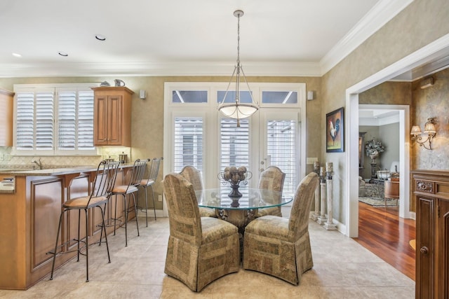 tiled dining area featuring crown molding