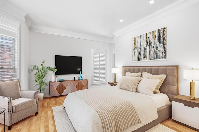 bedroom with light hardwood / wood-style floors and crown molding