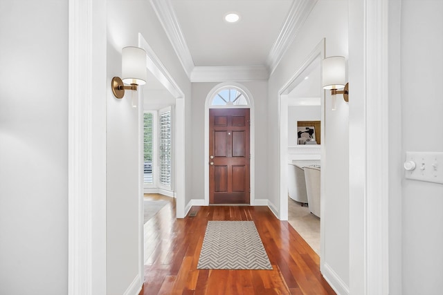 entrance foyer featuring wood-type flooring and crown molding