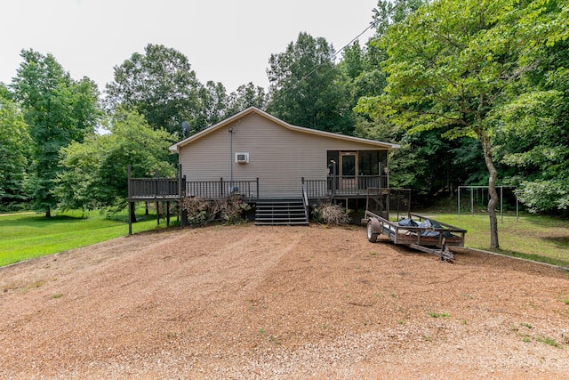 view of side of home with a sunroom, a yard, and a wooden deck