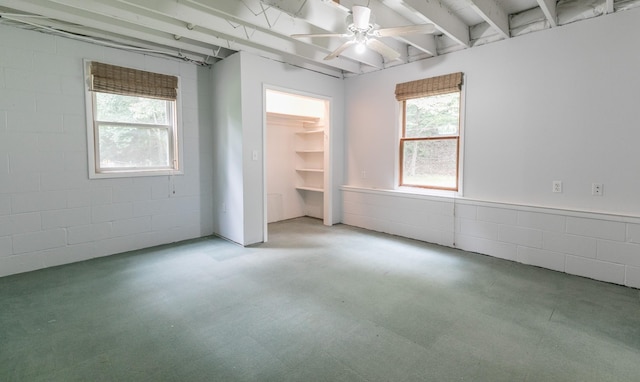 interior space featuring ceiling fan, a walk in closet, and a closet