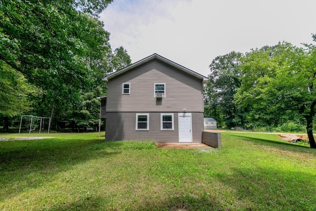 rear view of property with a lawn