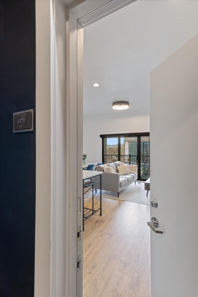 corridor with light hardwood / wood-style floors