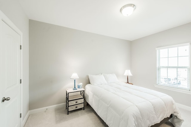 bedroom featuring light carpet