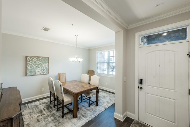 dining space featuring an inviting chandelier, dark wood-type flooring, and ornamental molding