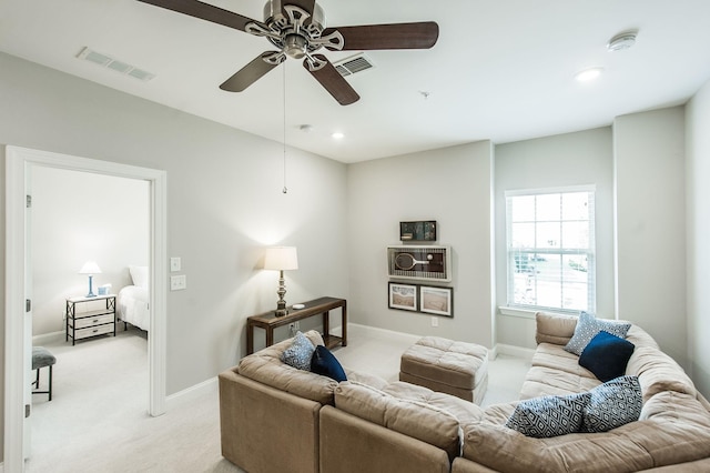 carpeted living room with ceiling fan