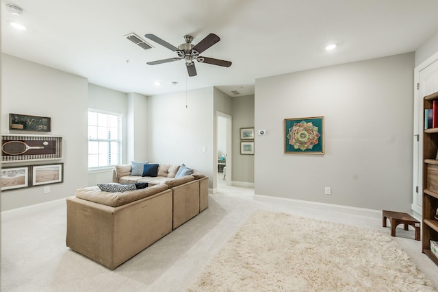 carpeted living room with ceiling fan