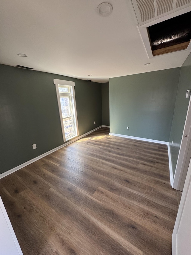 unfurnished room with wood finished floors and baseboards