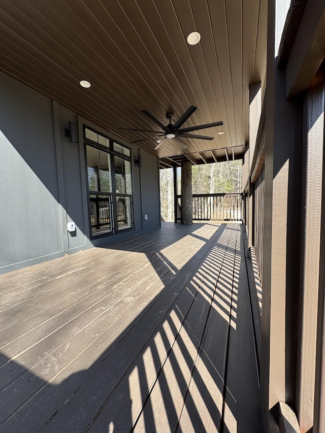 wooden deck with a porch and ceiling fan