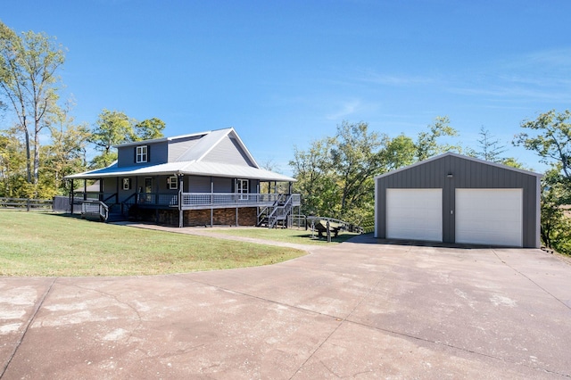 view of home's exterior featuring a yard, covered porch, an outdoor structure, and a garage