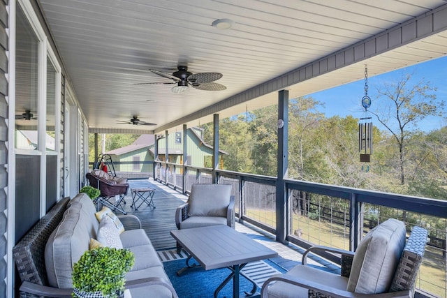 exterior space with ceiling fan and an outdoor living space