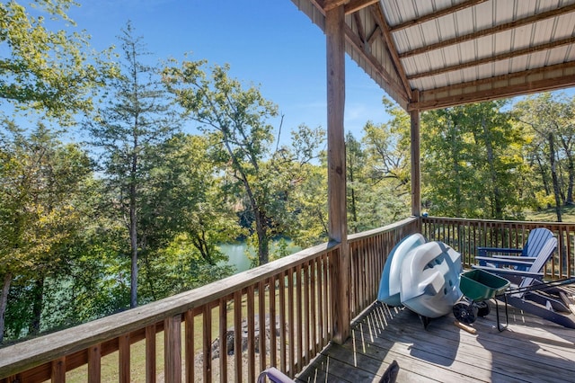 wooden terrace featuring a water view