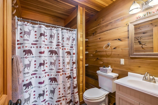 bathroom with wooden walls, vanity, a shower with shower curtain, and toilet