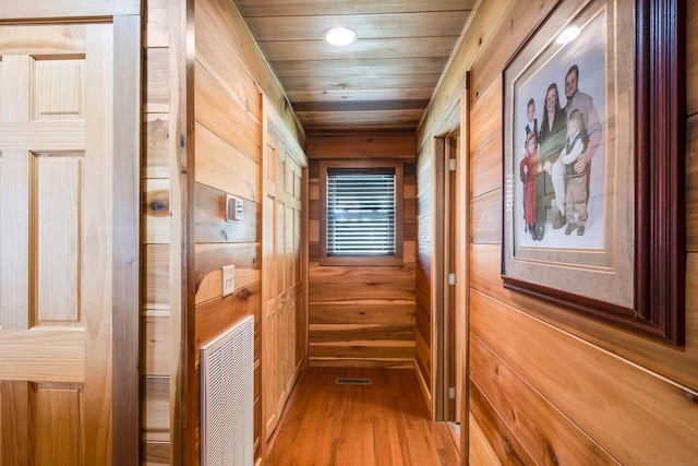 hallway with wood ceiling and wooden walls