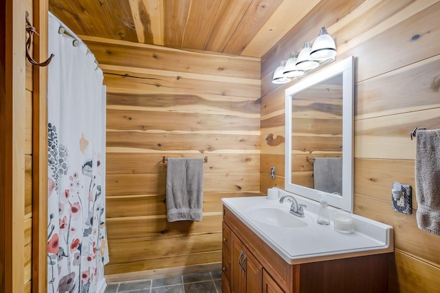 bathroom featuring a shower with curtain, vanity, wooden ceiling, and wooden walls