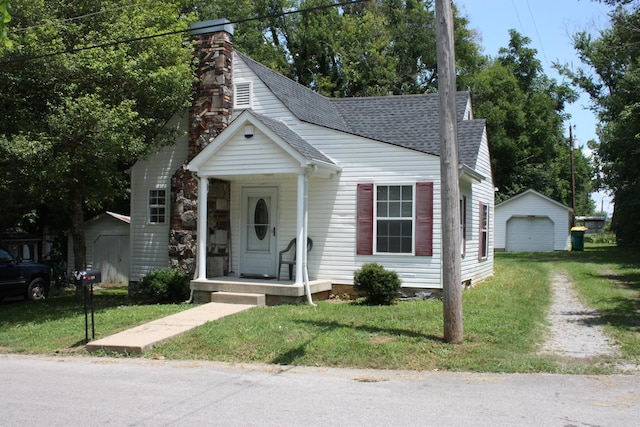 view of front of property with a front yard, a shed, and a garage