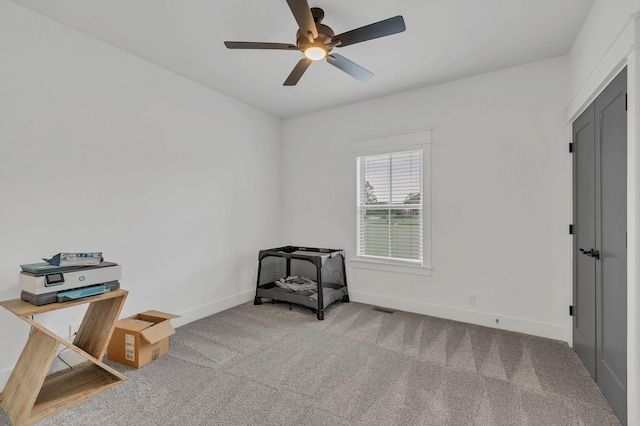 living area featuring ceiling fan and carpet floors