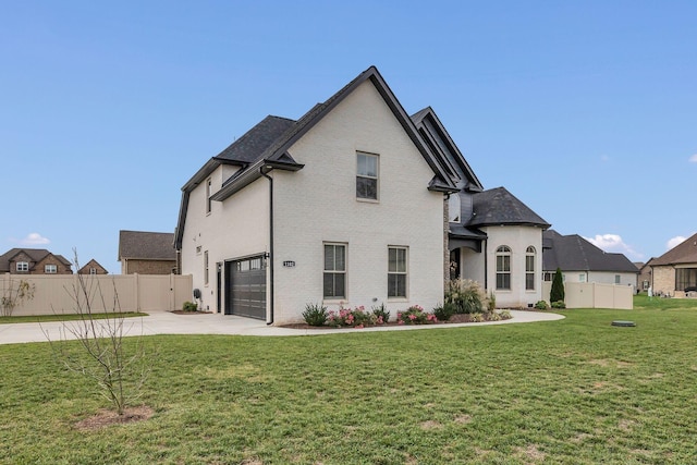 view of front facade featuring a garage and a front lawn